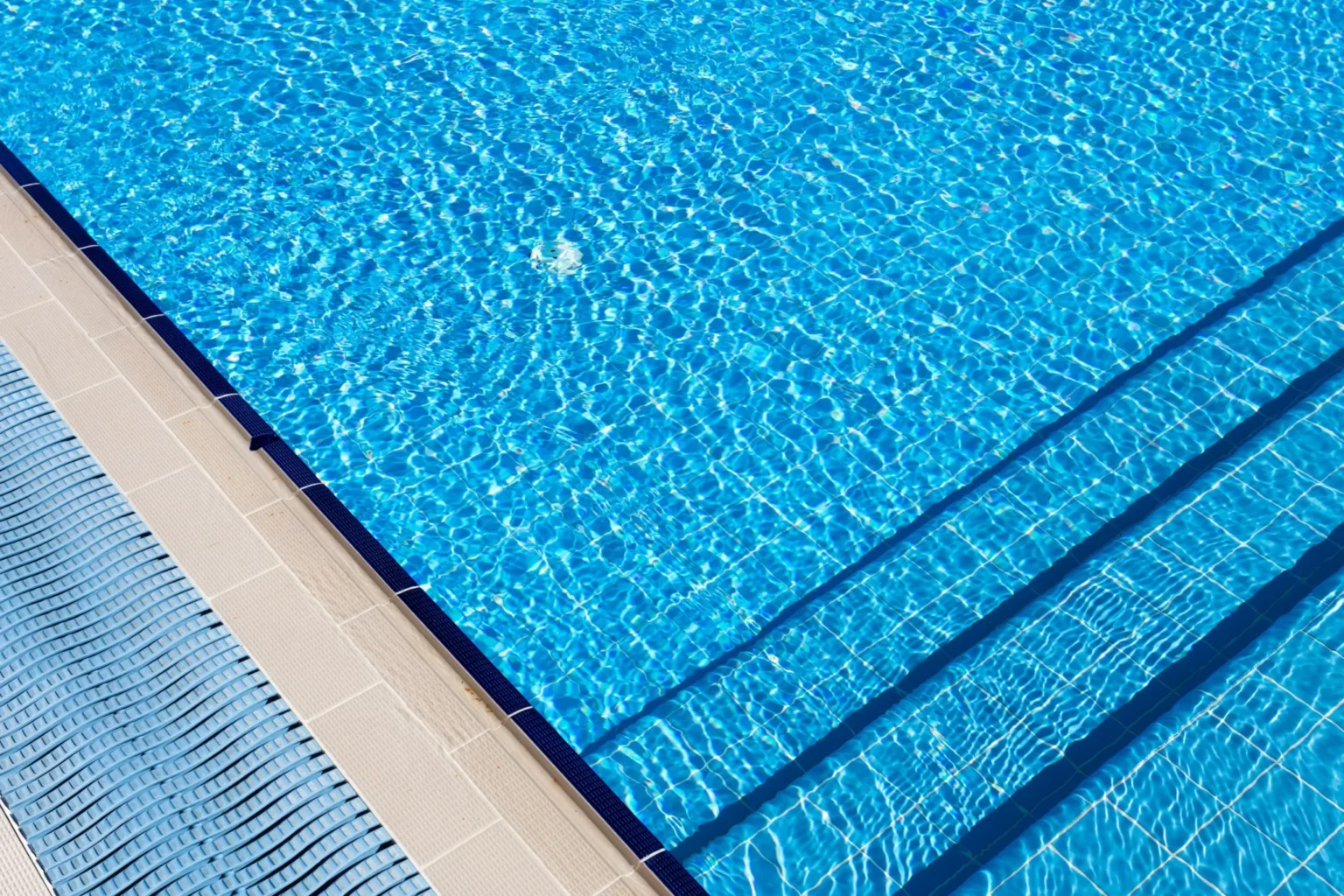 Crystal clear blue swimming pool with lane dividers